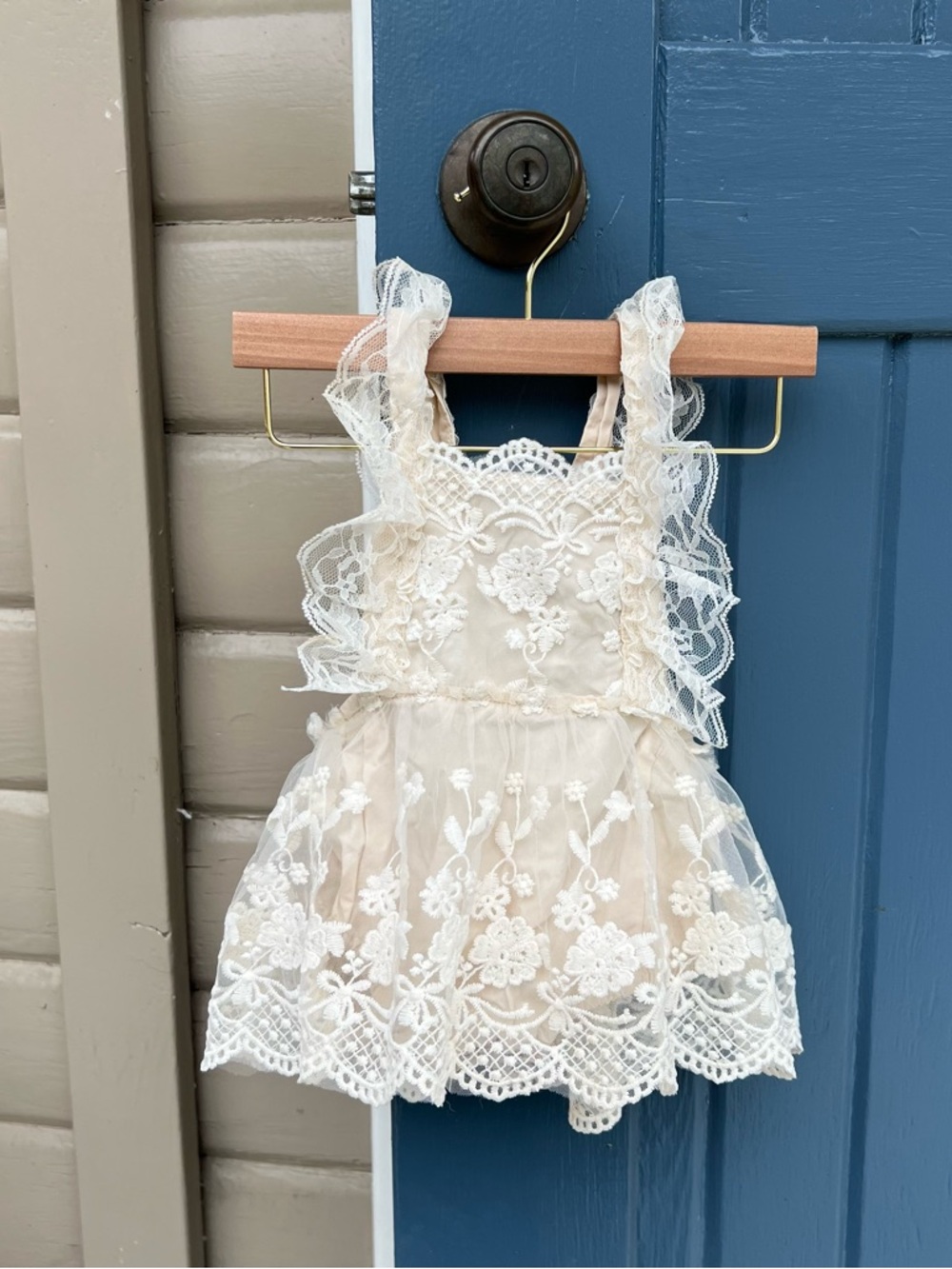 Vintage-style lace romper dress, cake smash photography prop.